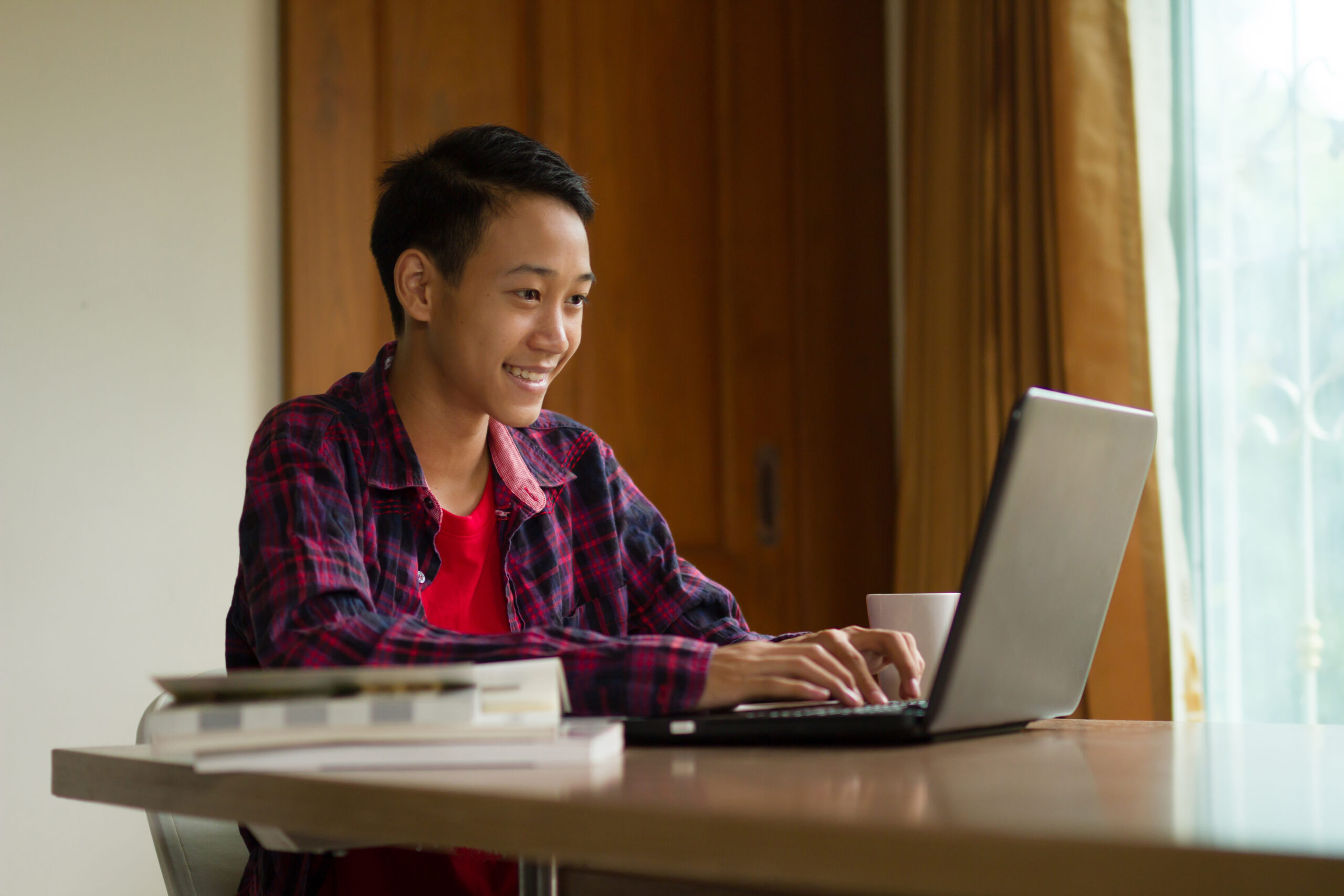 High school student working independently at a laptop